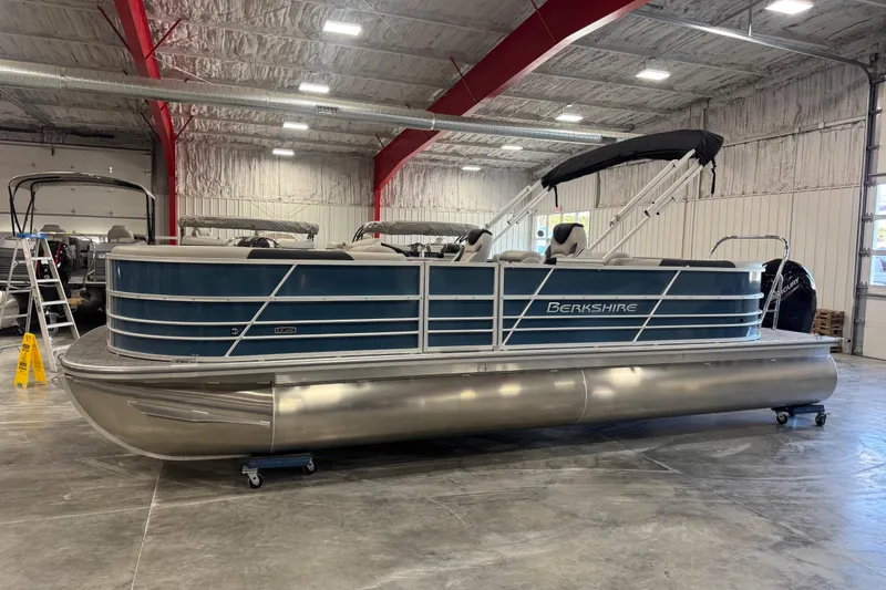 The Image of 2026 Berkshire 24 RFX LE pontoon boat in a spacious indoor showroom. - 1