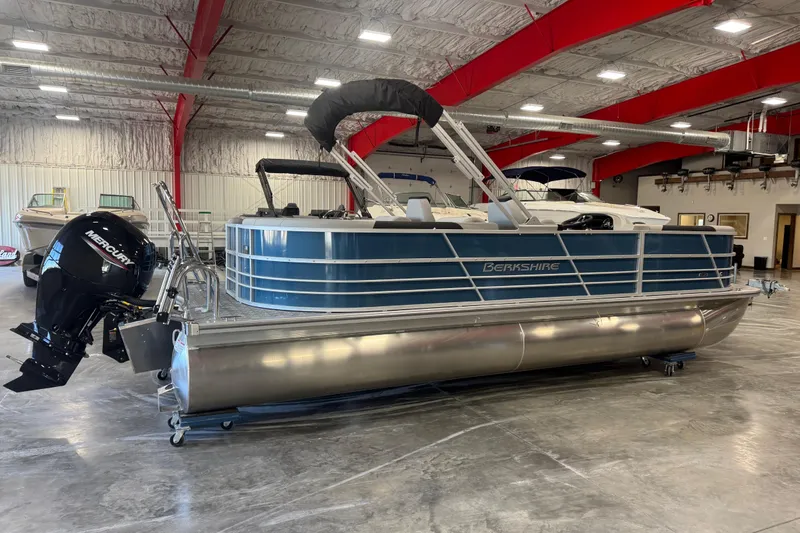 Slide: The Image of 2026 Berkshire 24 RFX LE pontoon boat in a showroom with Mercury outboard motor. - 3