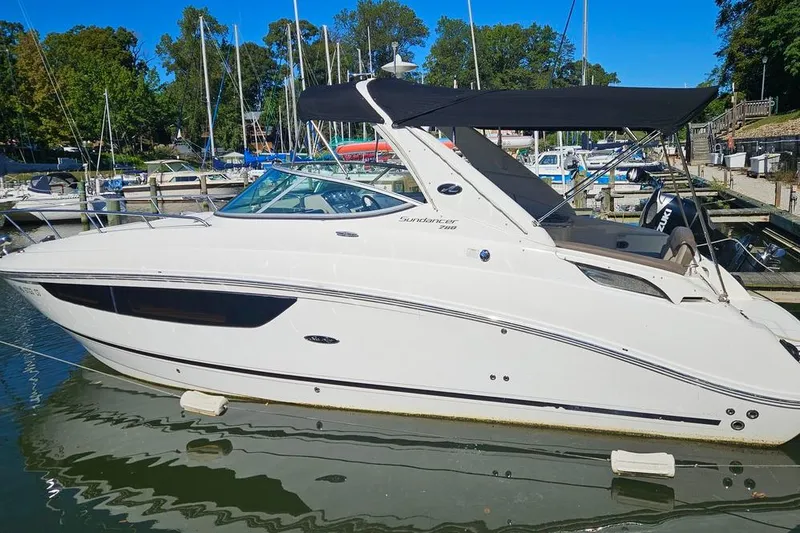 The Image of 2014 Sea Ray 280 Sundancer boat docked at a marina with trees in the background. - 0
