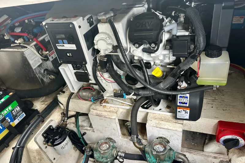 Slide: The Image of Engine compartment of a 2014 Sea Ray 280 Sundancer boat, featuring Kohler generator. - 21