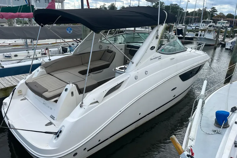 Slide: The Image of 2014 Sea Ray 280 Sundancer boat docked at a marina with black canopy. - 3
