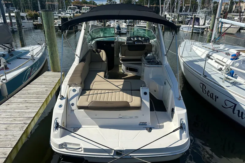 Slide: The Image of 2014 Sea Ray 280 Sundancer docked at marina, featuring spacious seating and sleek design. - 4