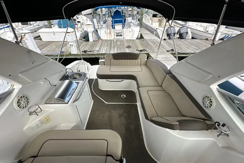 Slide: The Image of Interior of 2014 Sea Ray 280 Sundancer boat with seating and kitchenette at marina. - 5