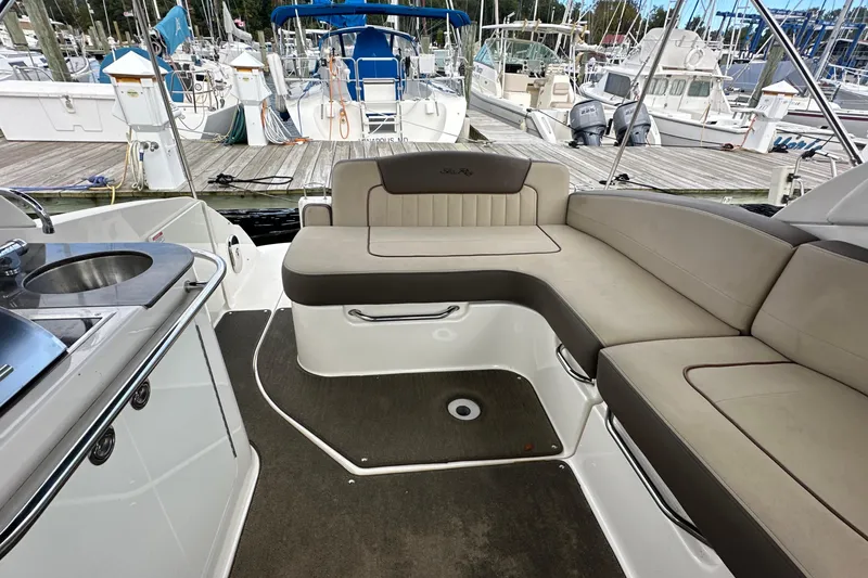 Slide: The Image of 2014 Sea Ray 280 Sundancer interior with seating and kitchenette at marina. - 8