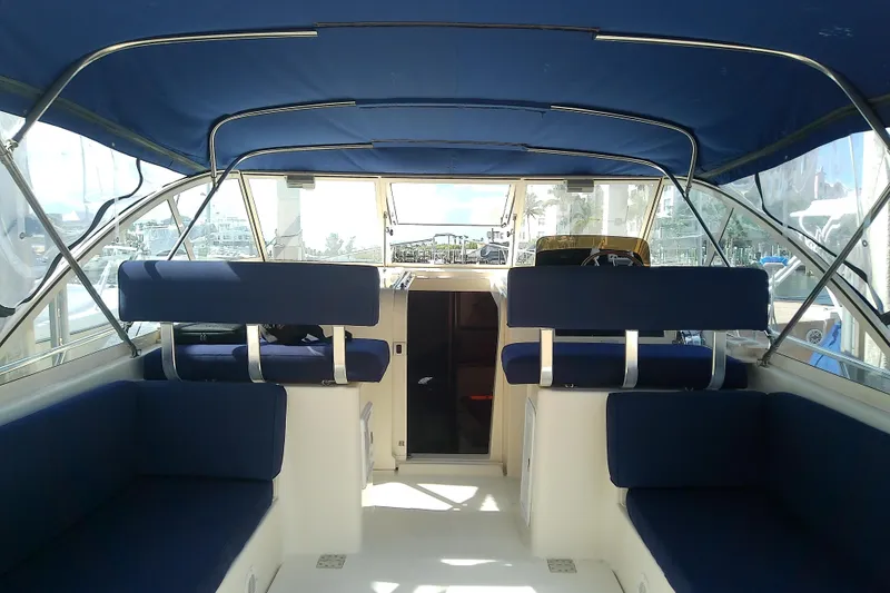 Slide: The Image of Interior view of 2004 Mainship 34 Pilot II boat with blue seating and canopy. - 13