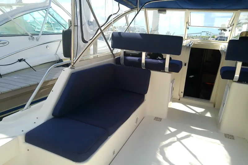 Slide: The Image of 2004 Mainship 34 Pilot II boat interior with blue cushioned seating. - 14