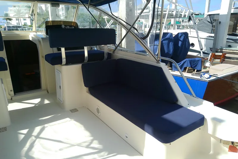Slide: The Image of 2004 Mainship 34 Pilot II boat interior with blue seating and open cockpit. - 15