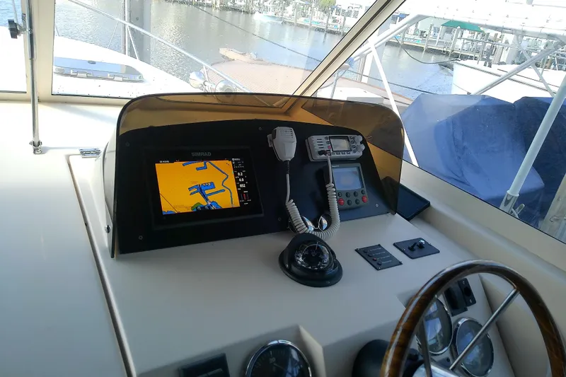 Slide: The Image of 2004 Mainship 34 Pilot II helm with navigation equipment and waterfront view. - 16