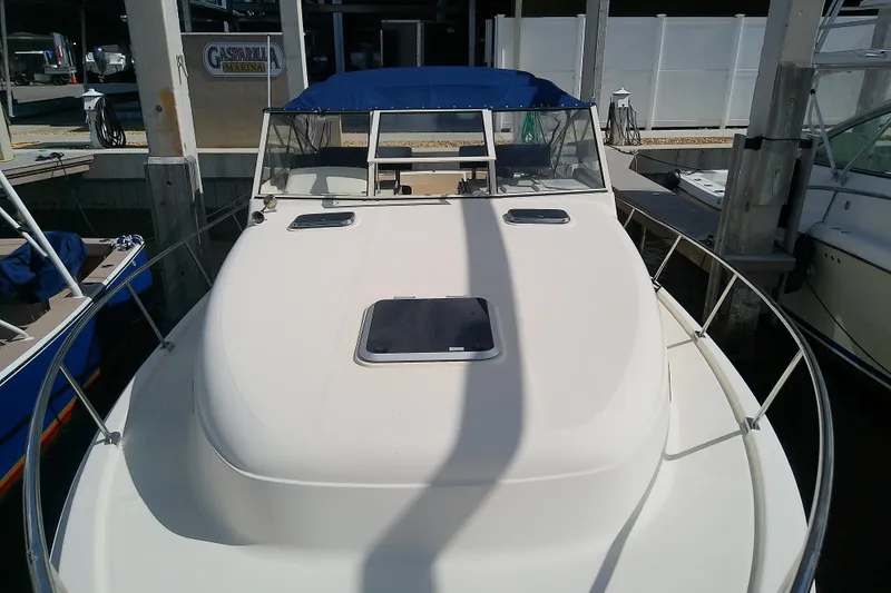 Slide: The Image of 2004 Mainship 34 Pilot II boat docked at marina with blue canopy. - 21