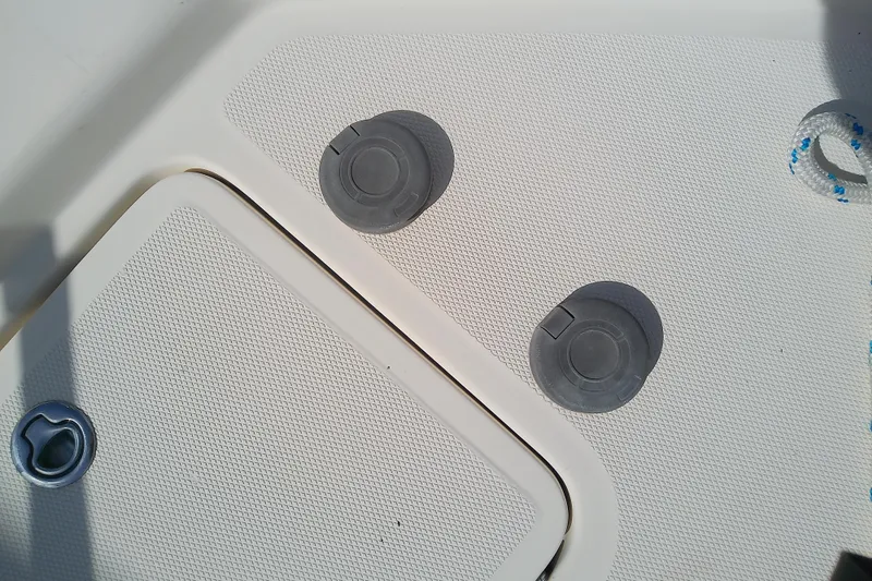 Slide: The Image of Deck fittings on a 2004 Mainship 34 Pilot II boat, featuring textured surfaces and rope detail. - 25
