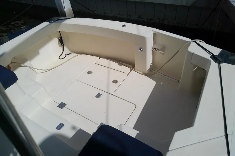 Slide: The Image of 2004 Mainship 34 Pilot II boat cockpit with seating and storage compartments. - 27
