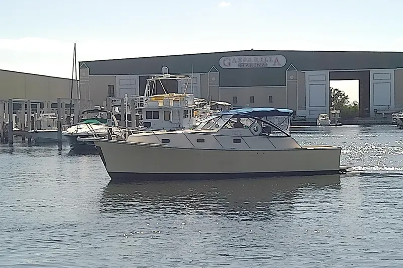 Slide: The Image of 2004 Mainship 34 Pilot II yacht docked at marina with blue canopy. - 3