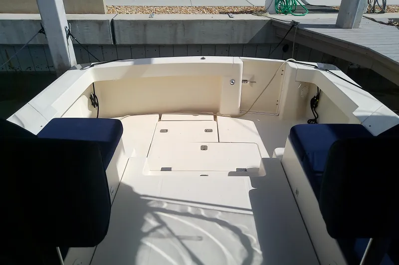 Slide: The Image of 2004 Mainship 34 Pilot II boat cockpit with seating and storage compartments. - 30