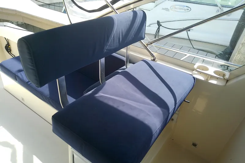 Slide: The Image of 2004 Mainship 34 Pilot II boat interior with blue cushioned seating. - 31