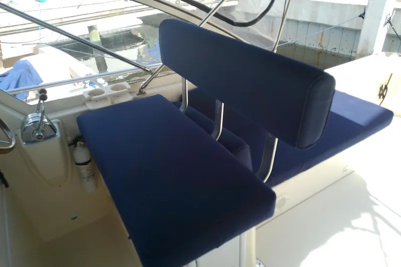 Slide: The Image of 2004 Mainship 34 Pilot II boat interior with blue cushioned seating. - 32