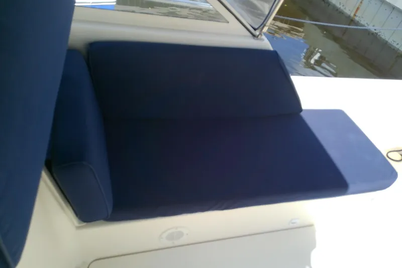 Slide: The Image of Blue cushioned seating on 2004 Mainship 34 Pilot II boat deck. - 33