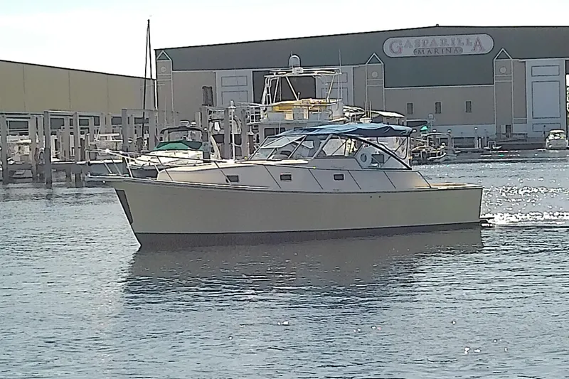 Slide: The Image of 2004 Mainship 34 Pilot II yacht docked at marina, sunny day. - 4