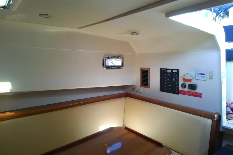 Slide: The Image of 2004 Mainship 34 Pilot II cabin interior with seating and control panel. - 42