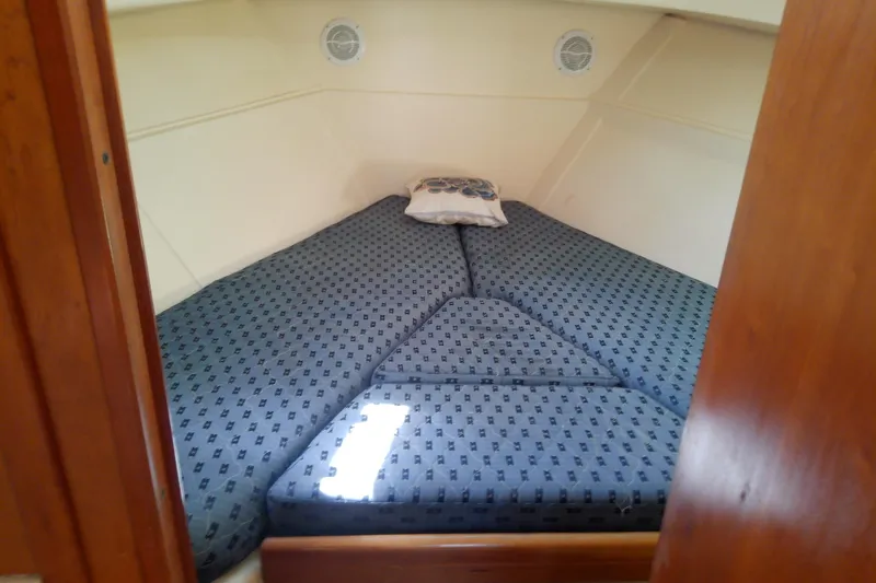 Slide: The Image of Cozy cabin interior of 2004 Mainship 34 Pilot II with patterned bedding. - 54