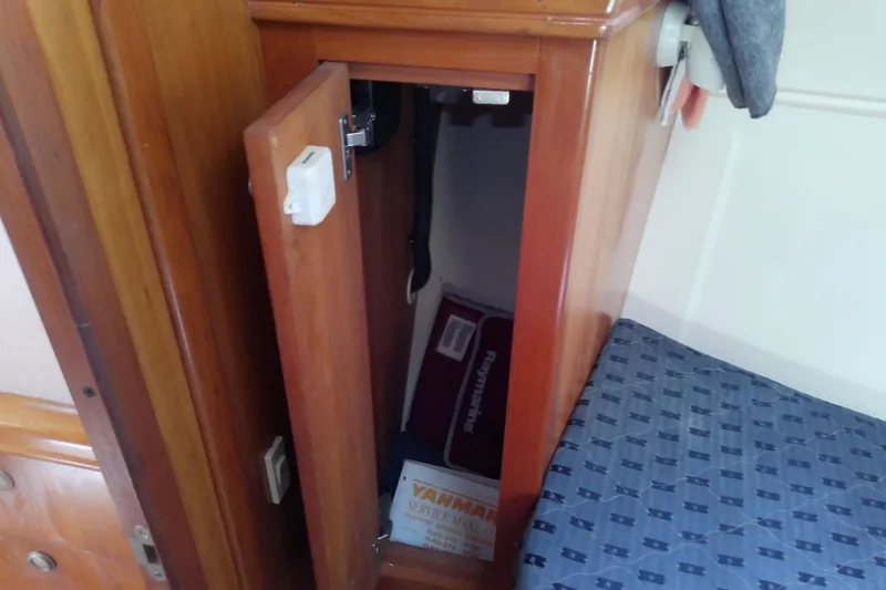Slide: The Image of Wooden cabinet with open door on 2004 Mainship 34 Pilot II boat interior. - 56