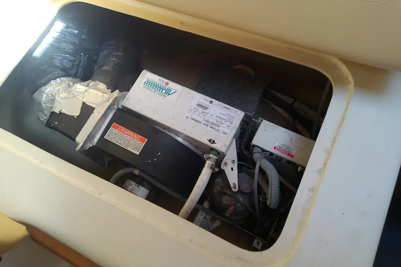 Slide: The Image of 2004 Mainship 34 Pilot II engine compartment with wiring and components. - 62