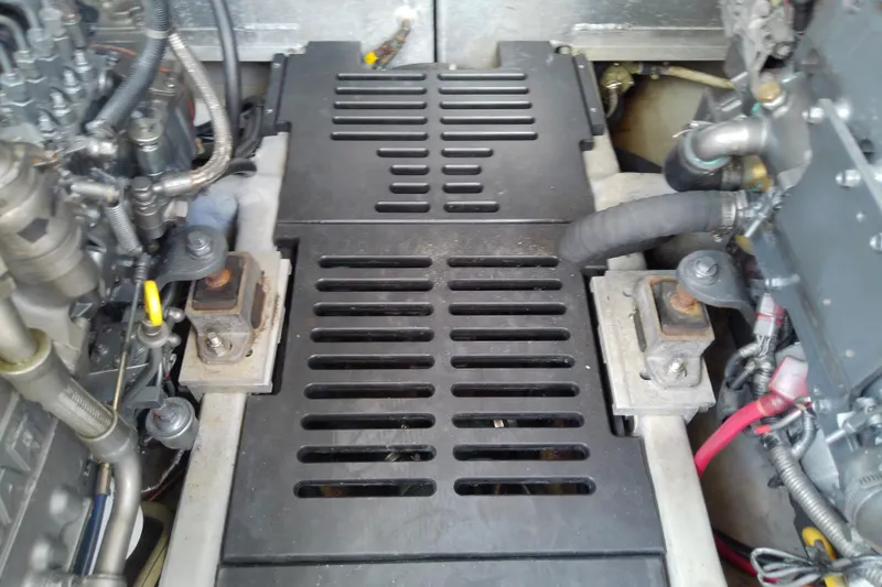 Slide: The Image of Engine compartment of a 2004 Mainship 34 Pilot II boat, showing mechanical components. - 66