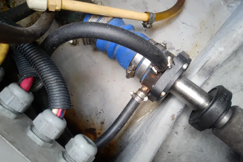 Slide: The Image of Engine compartment of 2004 Mainship 34 Pilot II with hoses and fittings. - 68