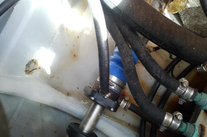 Slide: The Image of Engine compartment of 2004 Mainship 34 Pilot II with hoses and clamps. - 69