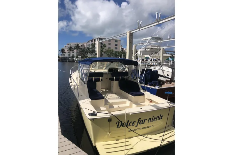 Slide: The Image of 2004 Mainship 34 Pilot II docked, featuring "Dolce far niente" on the stern. - 72