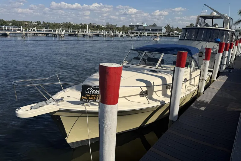 Slide: The Image of 2004 Mainship Pilot 34 Sedan docked at marina under clear skies. - 75
