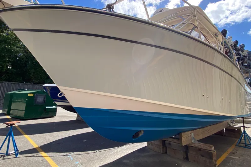 Slide: The Image of 2017 Grady-White Marlin 300 boat on stands, showcasing sleek design and blue hull. - 1