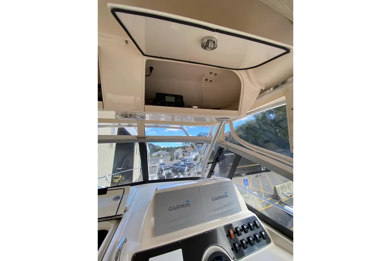 Slide: The Image of 2017 Grady-White Marlin 300 helm with Garmin electronics and overhead storage. - 10