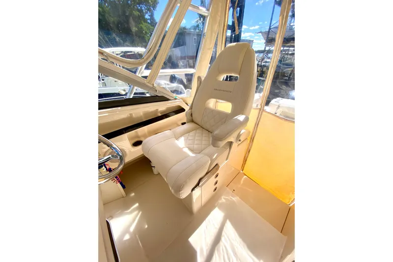 Slide: The Image of Captain's chair in 2017 Grady-White Marlin 300 boat cockpit, featuring luxurious design. - 11
