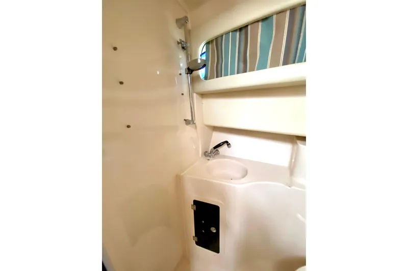 Slide: The Image of 2017 Grady-White Marlin 300 boat bathroom with sink and showerhead. - 17