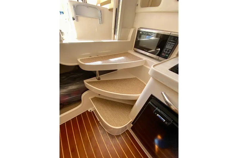 Slide: The Image of Interior of 2017 Grady-White Marlin 300 boat with carpeted steps and microwave. - 20