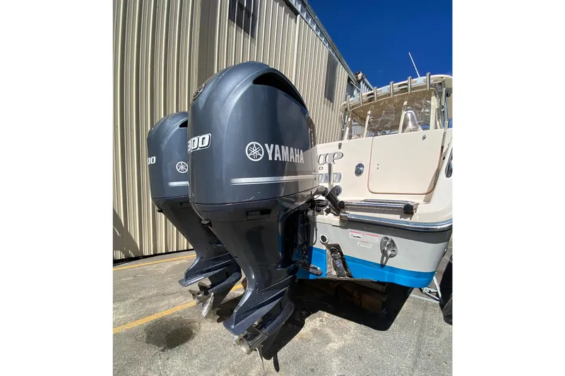 Slide: The Image of 2017 Grady-White Marlin 300 with twin Yamaha 300 outboard engines, docked near a building. - 3