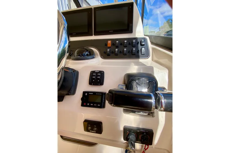 Slide: The Image of 2017 Grady-White Marlin 300 helm with dual screens and control panel. - 9