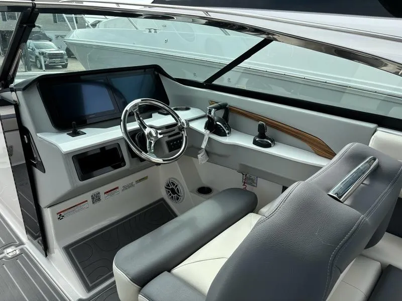 Slide: The Image of 2025 Regal LX9 boat cockpit with modern steering and dual screens. - 11