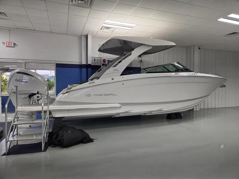 Slide: The Image of 2025 Regal LX9 boat displayed indoors, featuring sleek design and modern amenities. - 2