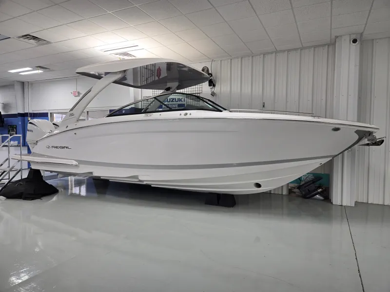 Slide: The Image of 2025 Regal LX9 boat displayed indoors, showcasing sleek design and modern features. - 3