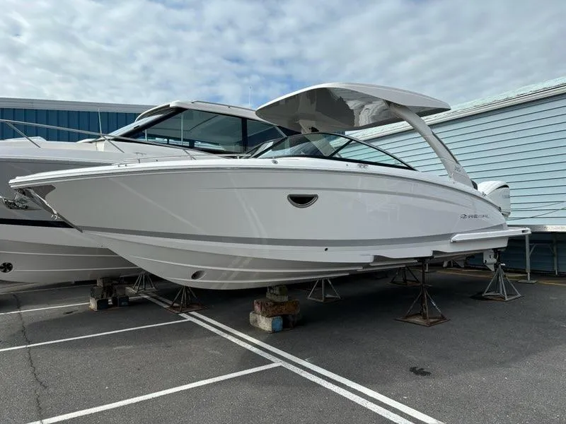 Slide: The Image of 2025 Regal LX9 boat on stands in a marina parking lot. - 5