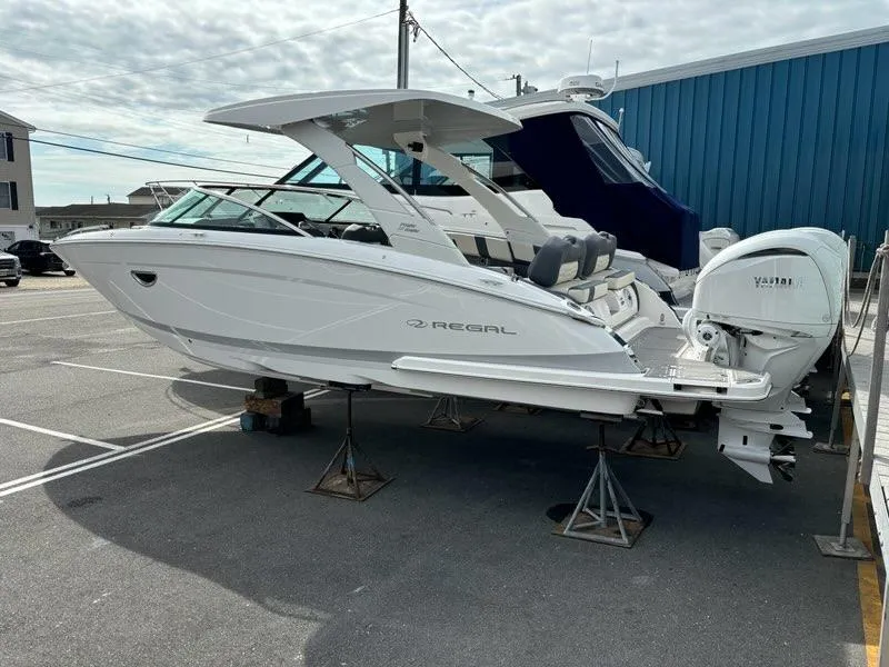 Slide: The Image of 2025 Regal LX9 boat on stands in a marina parking lot. - 6