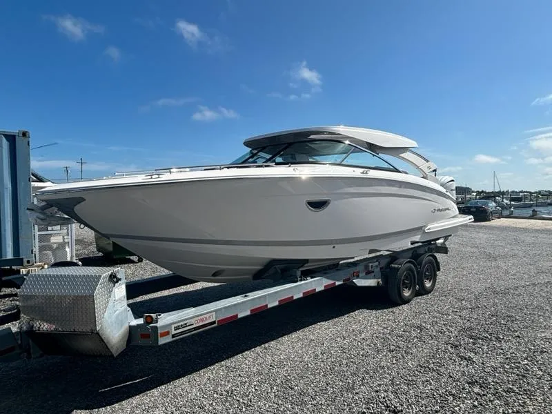 Slide: The Image of 2025 Regal LX9 boat on trailer under clear blue sky. - 7