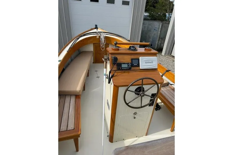 Slide: The Image of Interior of 2016 First Light Monomoy 26 boat with wooden helm and navigation equipment. - 6