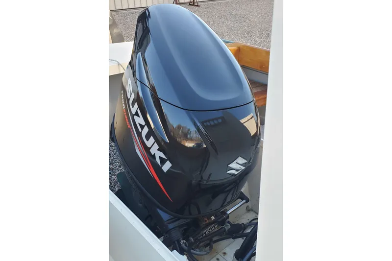 Slide: The Image of Suzuki outboard motor on 2016 First Light Monomoy 26 boat, close-up view. - 19