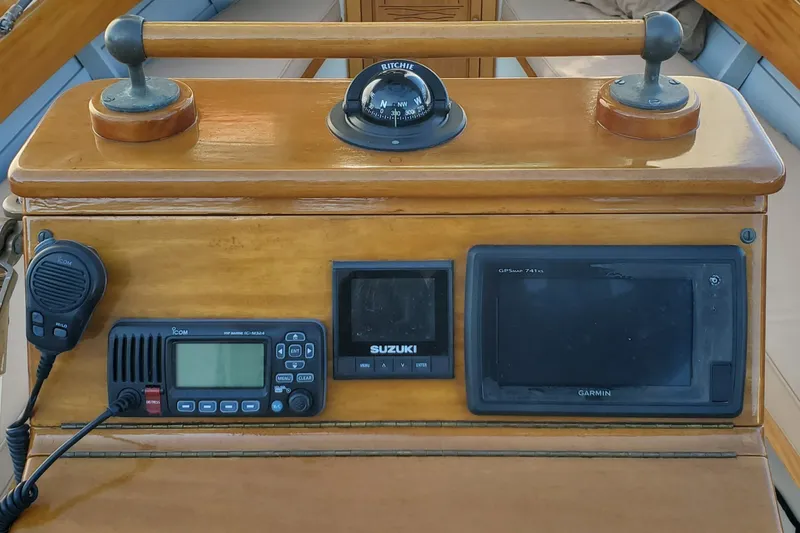 Slide: The Image of Wooden helm of 2016 First Light Monomoy 26 with navigation instruments and compass. - 21