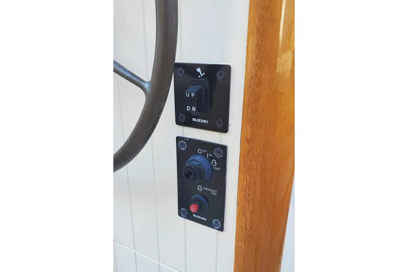 Slide: The Image of Boat control panel with Suzuki switches on a 2016 First Light Monomoy 26. - 17