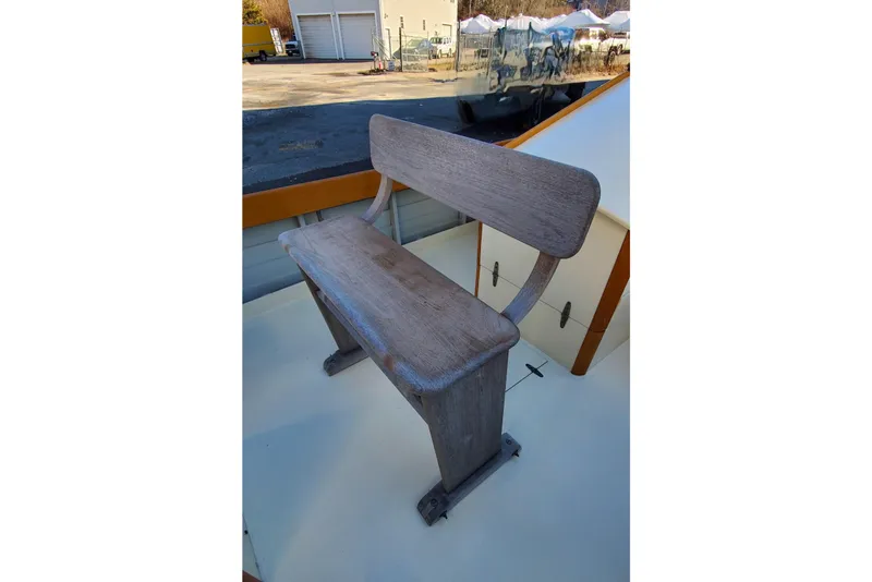 Slide: The Image of Wooden bench on First Light Monomoy 26 boat, 2016 model, in outdoor setting. - 10