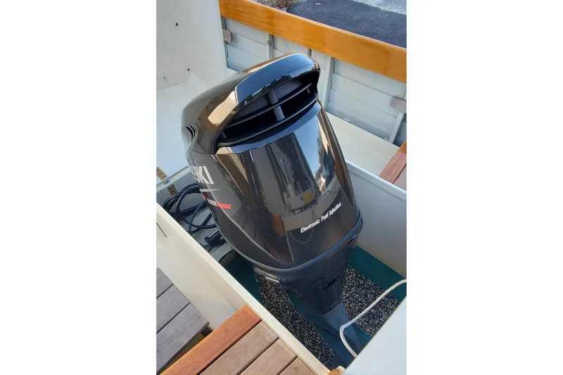 Slide: The Image of Outboard motor on 2016 First Light Monomoy 26 boat, featuring electronic fuel injection. - 16