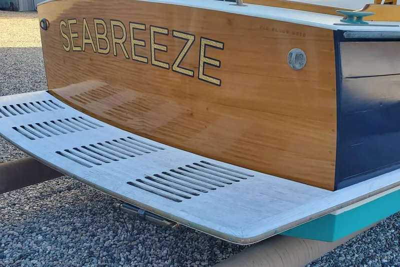 Slide: The Image of Wooden stern of First Light Monomoy 26 boat, named "Seabreeze," with swim platform. - 8